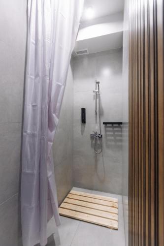 a bathroom with a shower with a shower curtain at Atakent Hostel in Almaty