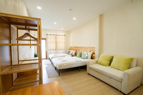 a living room with two beds and a couch at Yimwhan House 03, Chao Phrom Market Pier in Phra Nakhon Si Ayutthaya