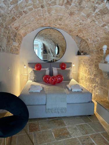 a bedroom with a bed with a stone wall at Cà Bella Vista in Ostuni