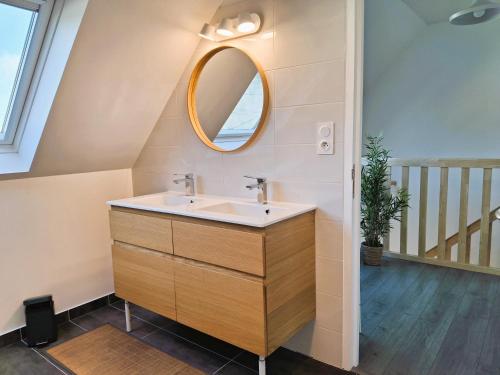 une salle de bain avec un lavabo et un miroir dans l'établissement Maison moderne proche plage Morgat, à Crozon