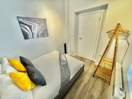 a bedroom with a white bed with pillows on it at Two Bedroom Apartment - Heart of Bournemouth - Free Parking - Sleeps 6 - Close to Town and Beach in Bournemouth