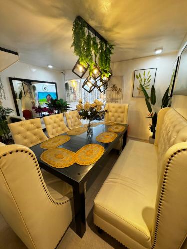 a dining room with a table and yellow chairs at Gray Room The White Haven In Clark in Angeles