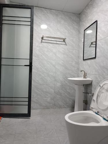 a bathroom with a shower and a toilet and a sink at Raya hotel juba in Juba