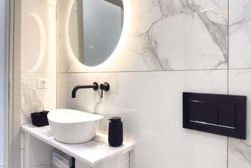 a bathroom with a sink and a mirror at Villa Redi Relaxing Spa in Piraeus