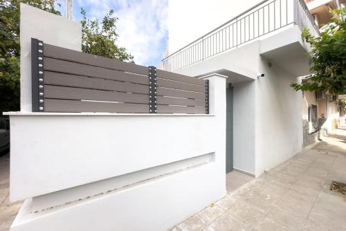 a black and white bench on the side of a building at Villa Redi Relaxing Spa in Piraeus
