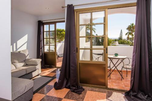 a living room with a couch and a table at Family Agua Amarga in Agua Amarga