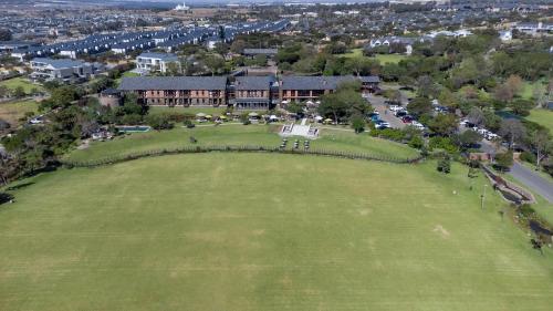 an aerial view of a large house on a green field at Riboville Boutique Hotel And Restaurant in Midrand