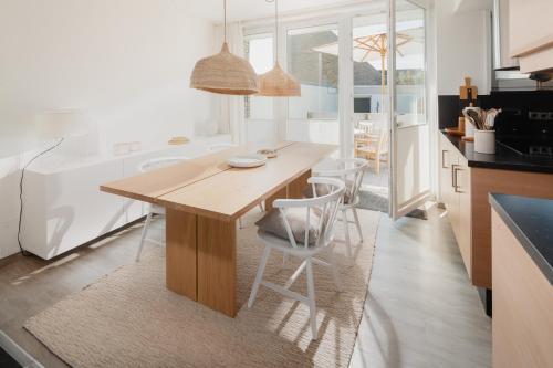 a kitchen with a wooden table and chairs at Freywind easy in Norderney