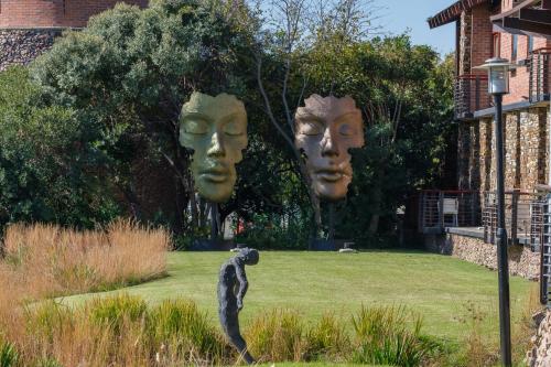 a black cat standing in a yard with two heads at Riboville Boutique Hotel And Restaurant in Midrand