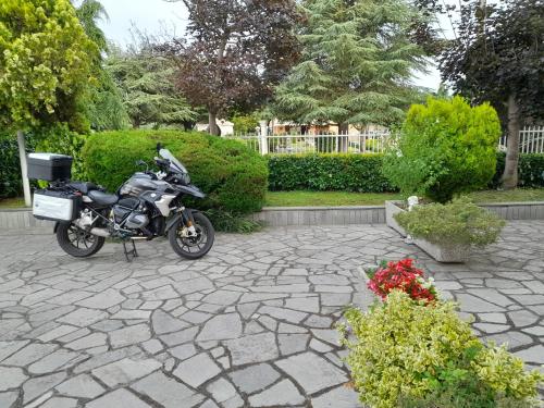 a motorcycle is parked on a stone patio at Da Betty in Asti