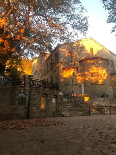 a large stone building with fire coming out of it at Nature Paradise Apartment in Kardítsa