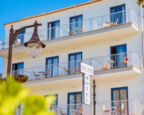 a hotel with a street sign in front of it at Hotel Miramar in Port de Soller