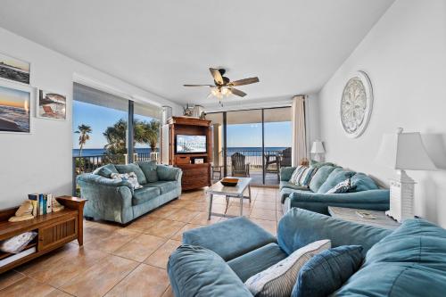 a living room with blue couches and a television at Bluewater Vacation Rentals in Orange Beach