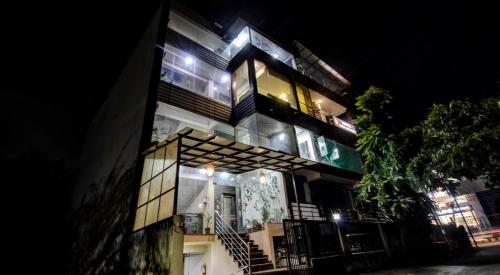 a tall building with lights on it at night at Hotel Surya Residency in Dehradun
