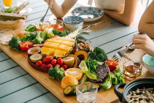 a table of food with vegetables and fruit on it at BohoLand in Zhushan
