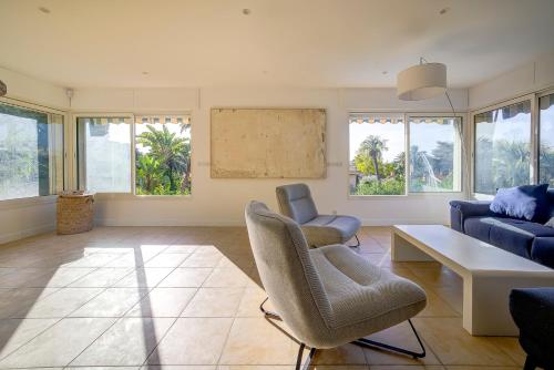 un salon avec un canapé, une table et des chaises dans l'établissement Villa rénovée- Vue mer- Centre de Cannes, à Cannes