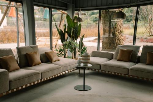 a living room with two couches and a table at BohoLand in Zhushan