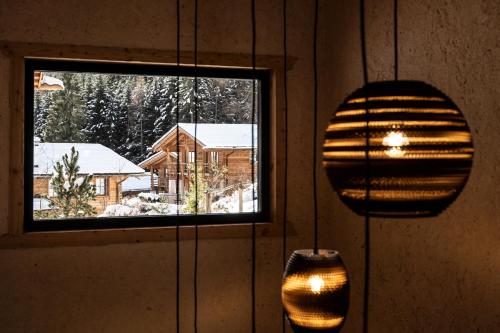 two lights hanging on a wall next to a window at Valsegg Chalets Südtirol - luxury and private hideaway in Valles
