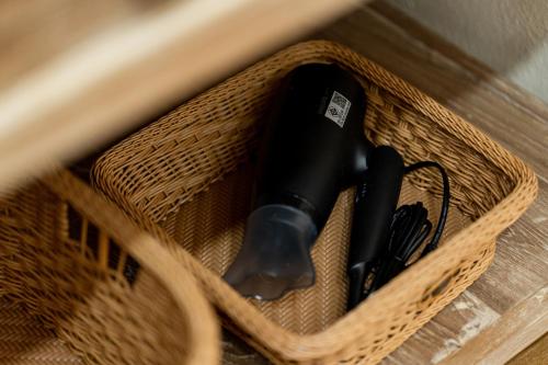 a wicker basket with a black object in it at Yimwhan House 03, Chao Phrom Market Pier in Phra Nakhon Si Ayutthaya