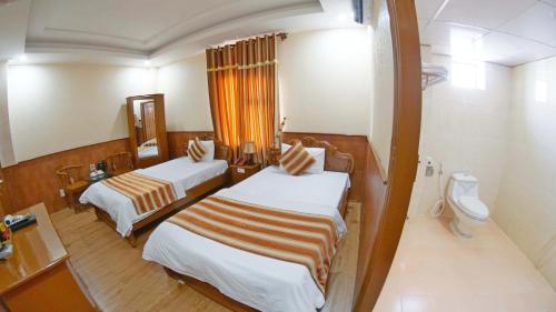 Postel nebo postele na pokoji v ubytování Kieu Anh Hotel Vung Tau