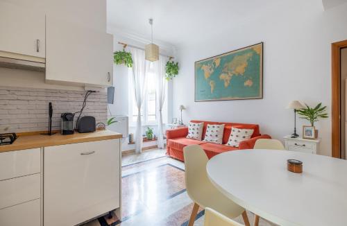 a kitchen and living room with a table and a couch at Maurice's Apt, hidden gem in Rome for food lovers in Rome