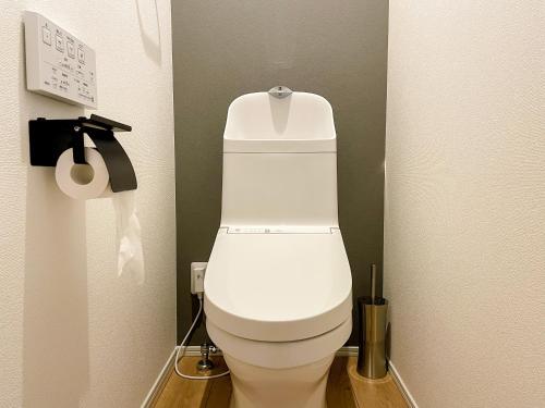 a bathroom with a white toilet in a stall at Niseko White Villas I in Kombu