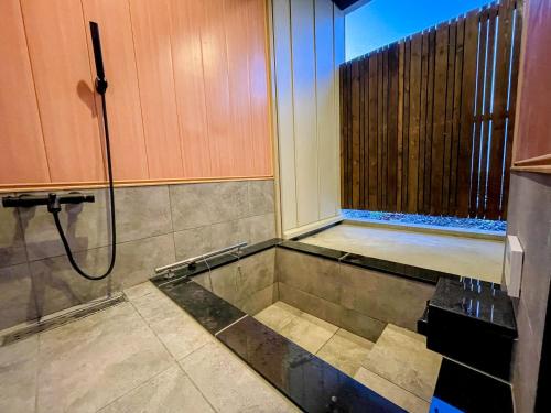 a bathroom with a shower and a sink at Niseko White Villas I in Kombu