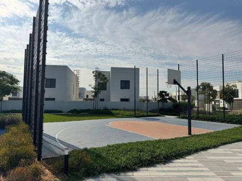 a basketball court in front of a building at 4br Luxury Villa Yas Island Near F1 in Abu Dhabi