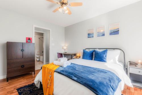 a bedroom with a large bed and a ceiling fan at EmeraldRidge Retreat - 180 Degree Amazing View & Firepit & BBQ in Chilliwack
