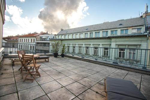 a balcony with a table and chairs on a building at K+K Hotel Fenix in Prague