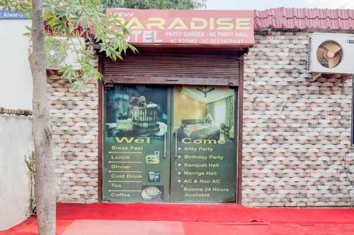 a store window with a sign for a cake shop at New paradise hotel &restaurant in Alwar