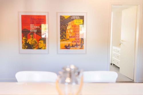 a dining room with two movie posters on the wall at Ferienwohnung "Kino" in Bad Gandersheim