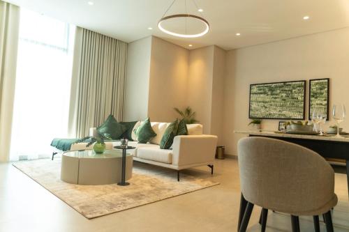 a living room with a couch and a table at Pearlhouse Bahrain in Manama