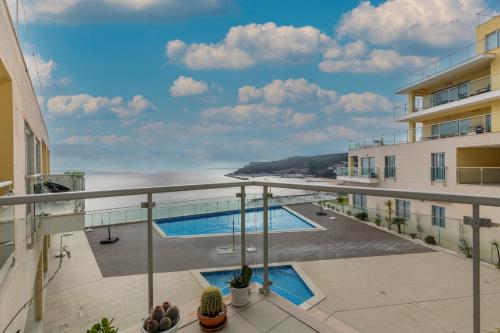 a view of the ocean from the balcony of a building at Cliffs Apartment - Astonishing view over Sesimbra bay by Trip2Portugal in Sesimbra