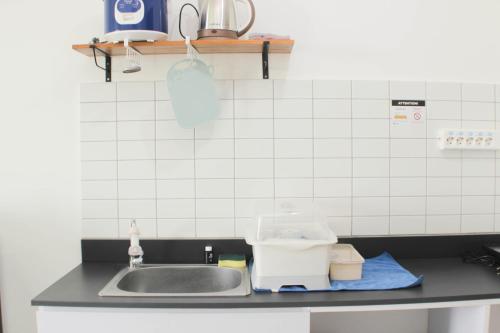 a kitchen counter top with a sink and a counter top at Fancy and Nice Studio Apartment at Sayana Bekasi By Travelio in Bekasi