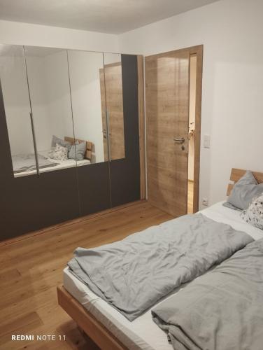 a bedroom with a bed and a walk in shower at Jans BioHof in Anthering