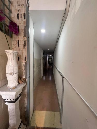 a long hallway with a vase on a shelf at The Moonvine on 360 in Phnom Penh