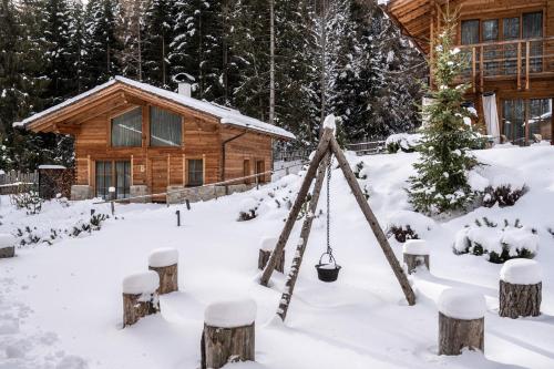 a log cabin in the snow at Valsegg Chalets Südtirol - luxury and private hideaway in Valles