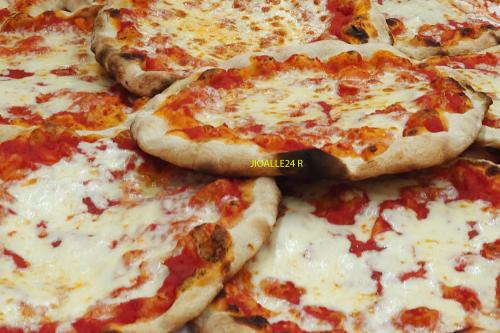 a group of pizzas sitting on a table at Casa Vacanze Piazza Apartment 2 in SantʼAndrea di Conza