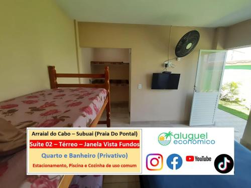 a bedroom with a bed and a clock on the wall at Arraial do Cabo – Subuai Village - Aluguel Econômico in Arraial do Cabo