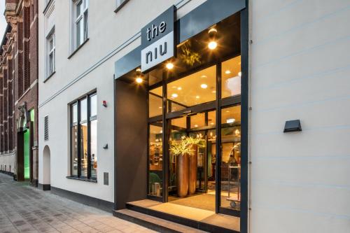 a store front of a building with glass windows at Holiday Inn - the niu, Rig Lübeck by IHG in Lübeck