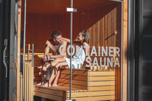 a man and woman sitting on the back of a boat at ALPENHOTEL TYROL - B&B - ADULTS ONLY - Alpines Lifestyle-Konzepthotel - dog friendly in Pertisau