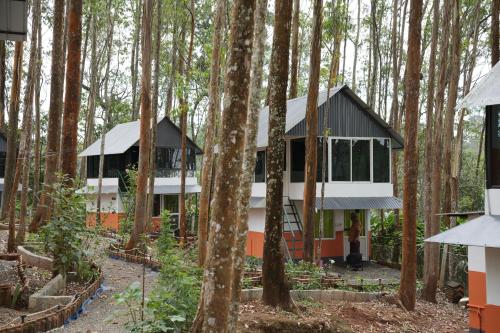 a house in the woods with trees at Ventos Tent Stay and Aframes in Anachal