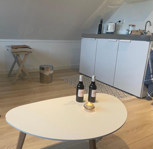 two bottles of wine sitting on a white table at De Fugelsang in Jonkersland