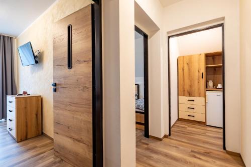 a room with a wooden door and a bedroom at Penzion Kormorán in Vranov nad Dyjí