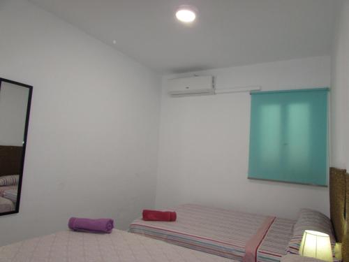 a white room with a bed and a mirror at MOJACAR HOME AND BEACH in Mojácar