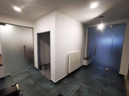 an empty room with two doors and a tile floor at Family Apartments Černice in Mojné