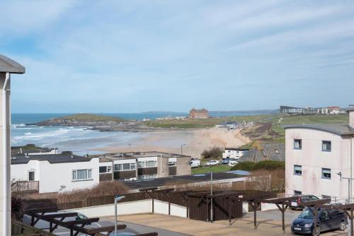 a view of the beach from a balcony of a building at Spacious Flat Sea Views & Private Parking Fistral in Newquay