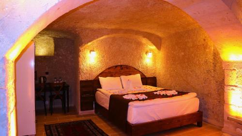 a bedroom with a bed in a stone room at akile ablanın evi in Urgup