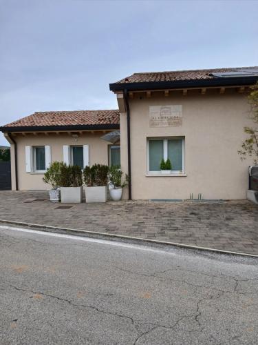 a building with potted plants on the side of it at Al Giorgione in Caselle